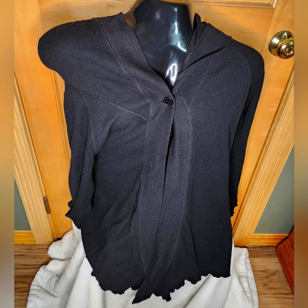 Women's hooded wrap with one button closure.